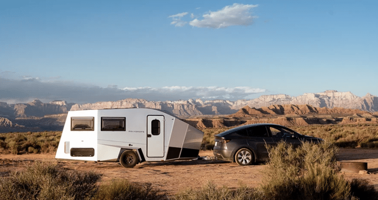 Black Sedan With Camper Trailer Behind It